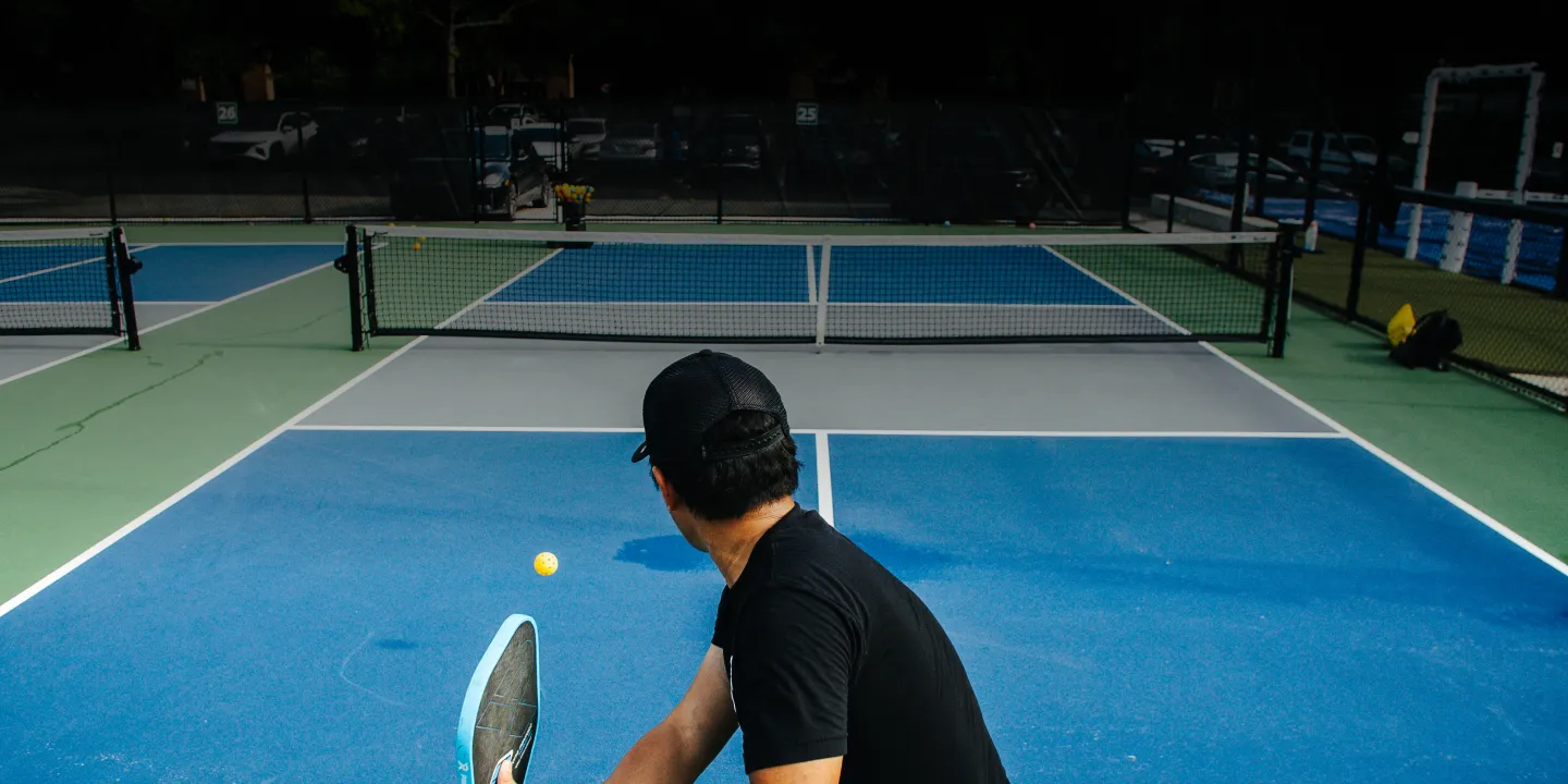 Tennibot Station and Rover tennis ball machines on the court