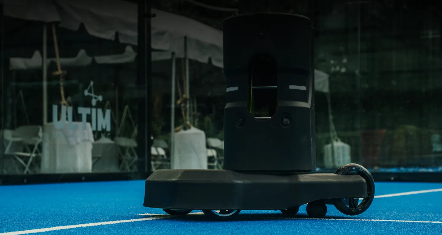 Tennibot Station and Rover tennis ball machines on the court