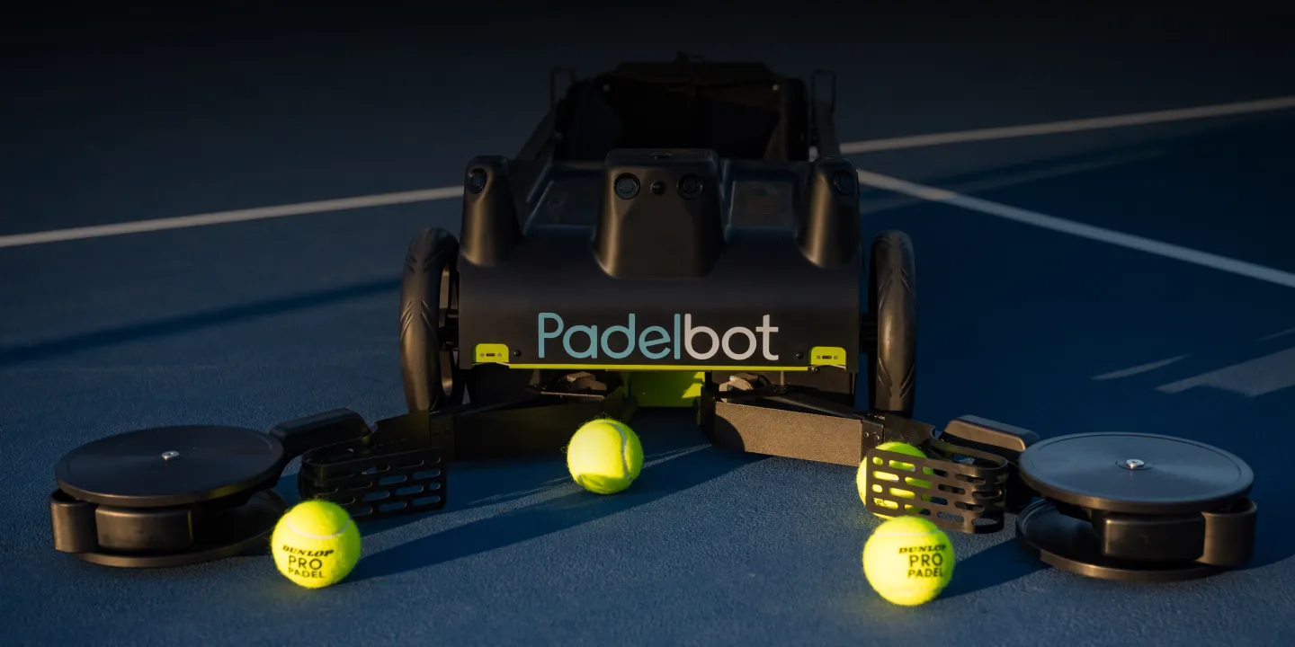 Tennibot Station and Rover tennis ball machines on the court