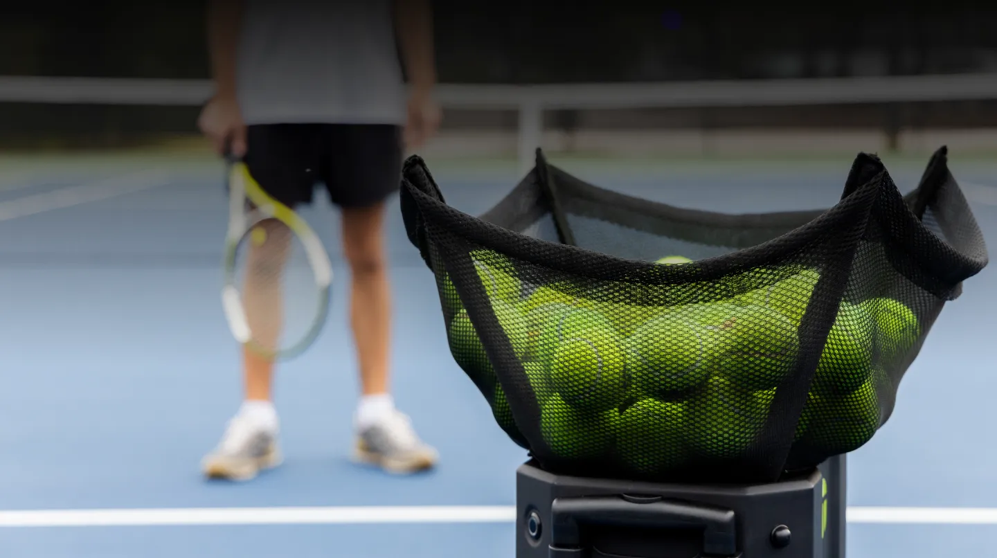 Tennibot Station and Rover tennis ball machines on the court