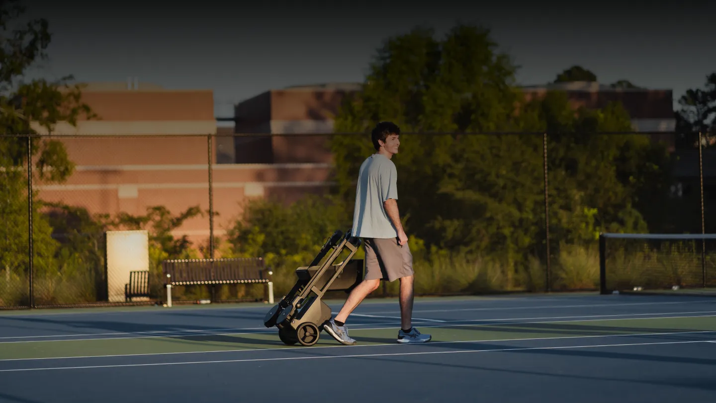 Tennibot Station and Rover tennis ball machines on the court